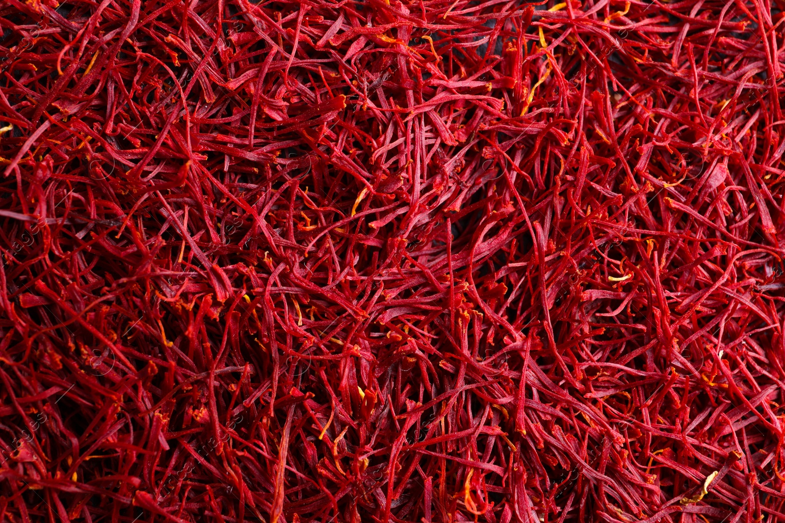 Photo of Aromatic dried saffron as background, top view