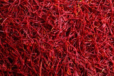 Aromatic dried saffron as background, top view