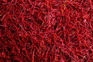 Photo of Aromatic dried saffron as background, top view