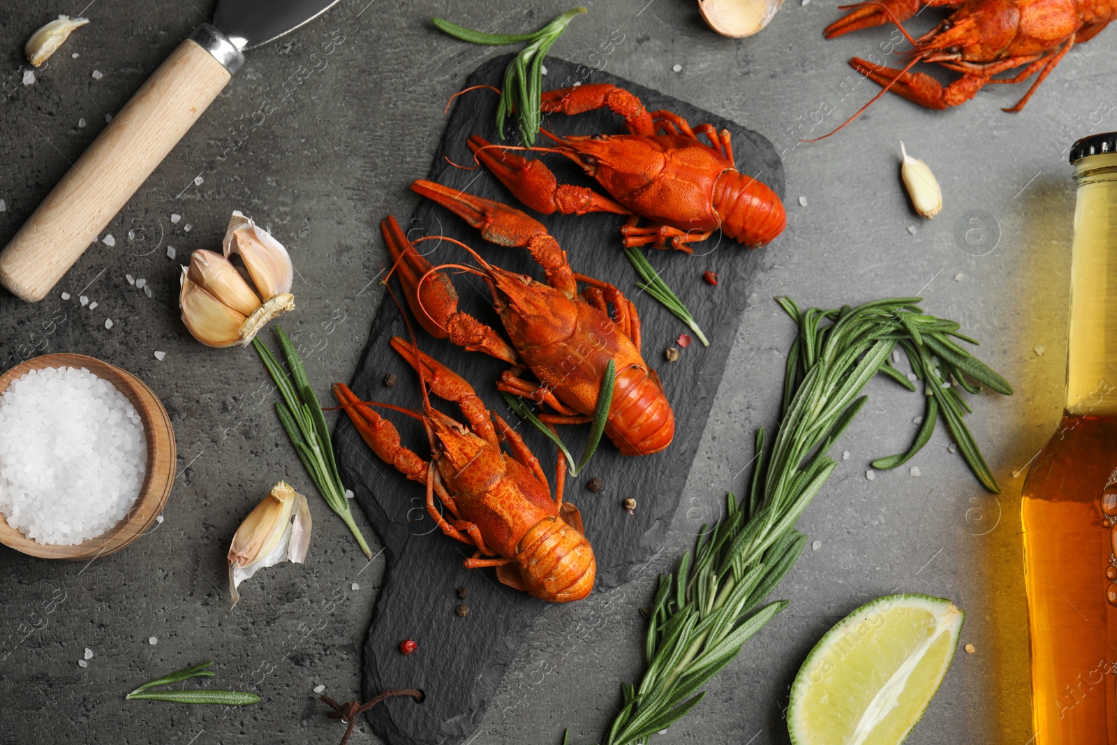 Photo of Flat lay composition with delicious red boiled crayfishes on black table