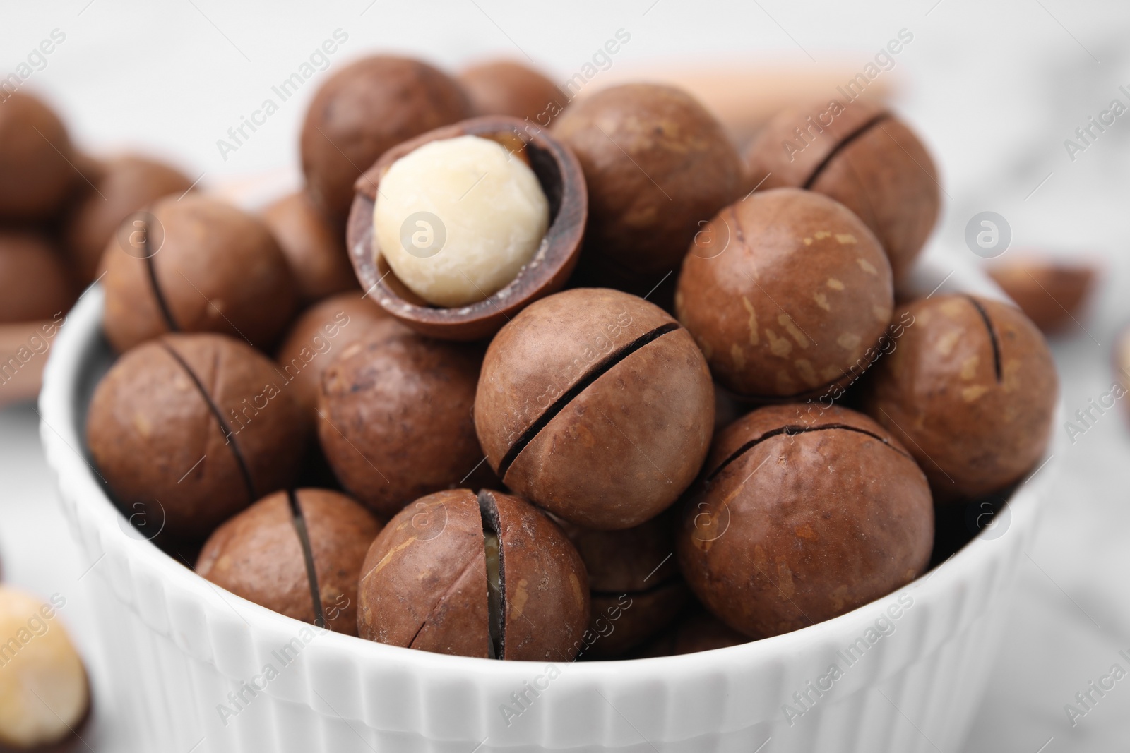 Photo of Tasty Macadamia nuts in bowl, closeup view