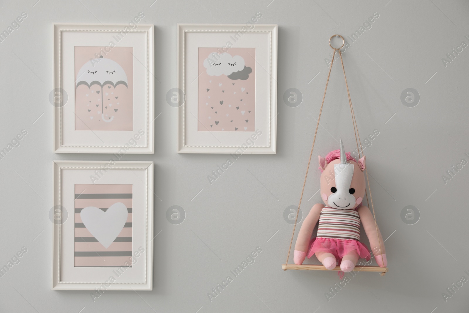 Photo of Different cute pictures on grey wall. Baby room interior