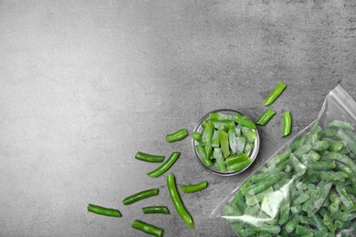 Photo of Flat lay composition with frozen green beans on grey background. Vegetable preservation