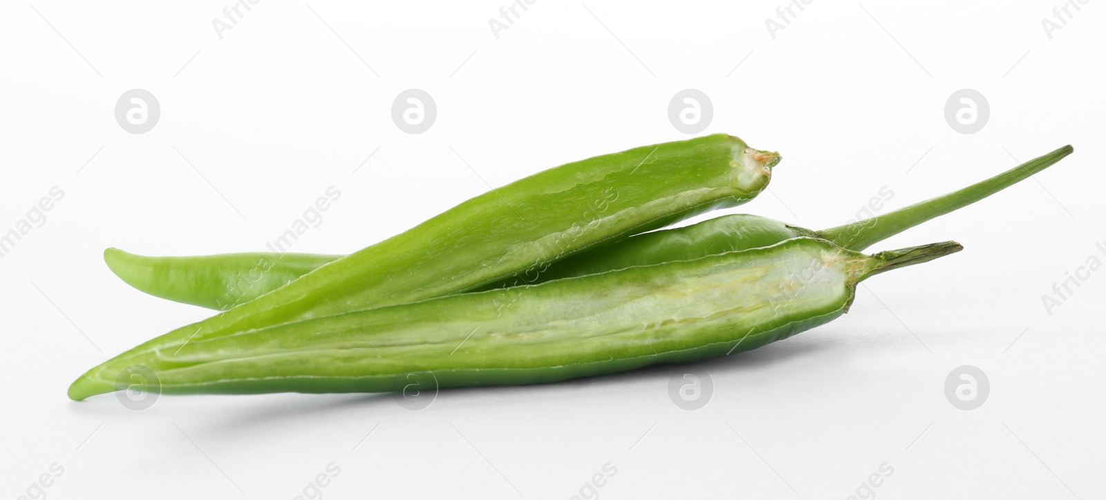 Photo of Cut ripe chili peppers on white background