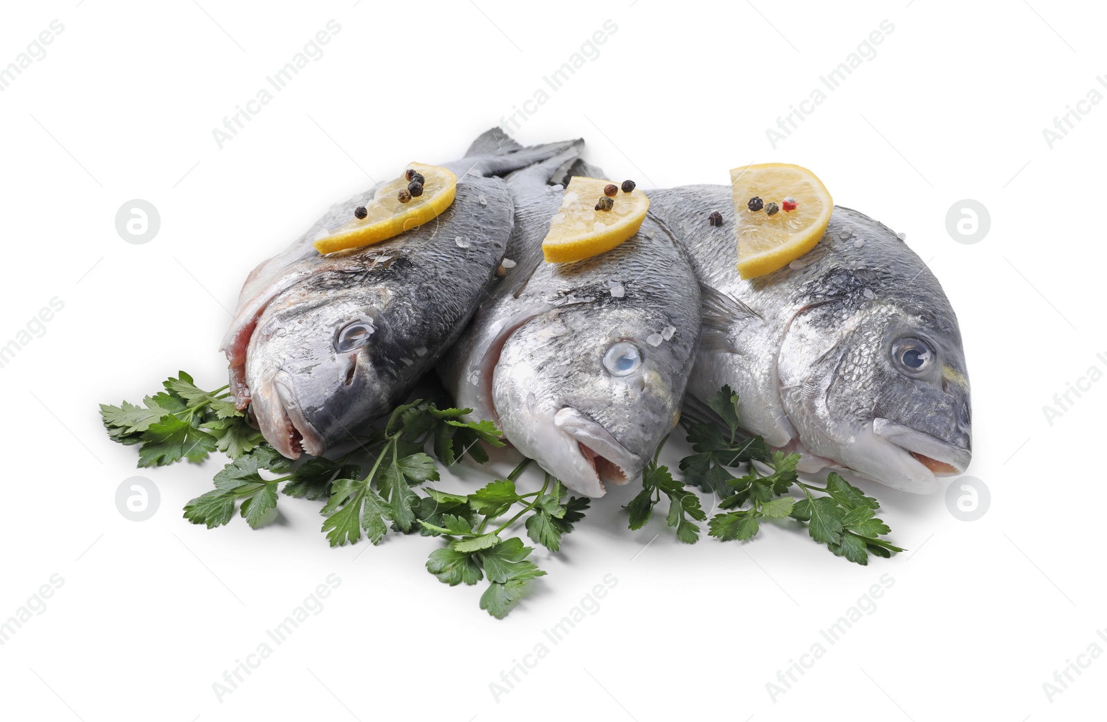 Photo of Raw dorado fish, parsley, lemon slices and peppercorns isolated on white