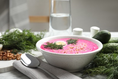 Photo of Delicious cold summer beet soup on table