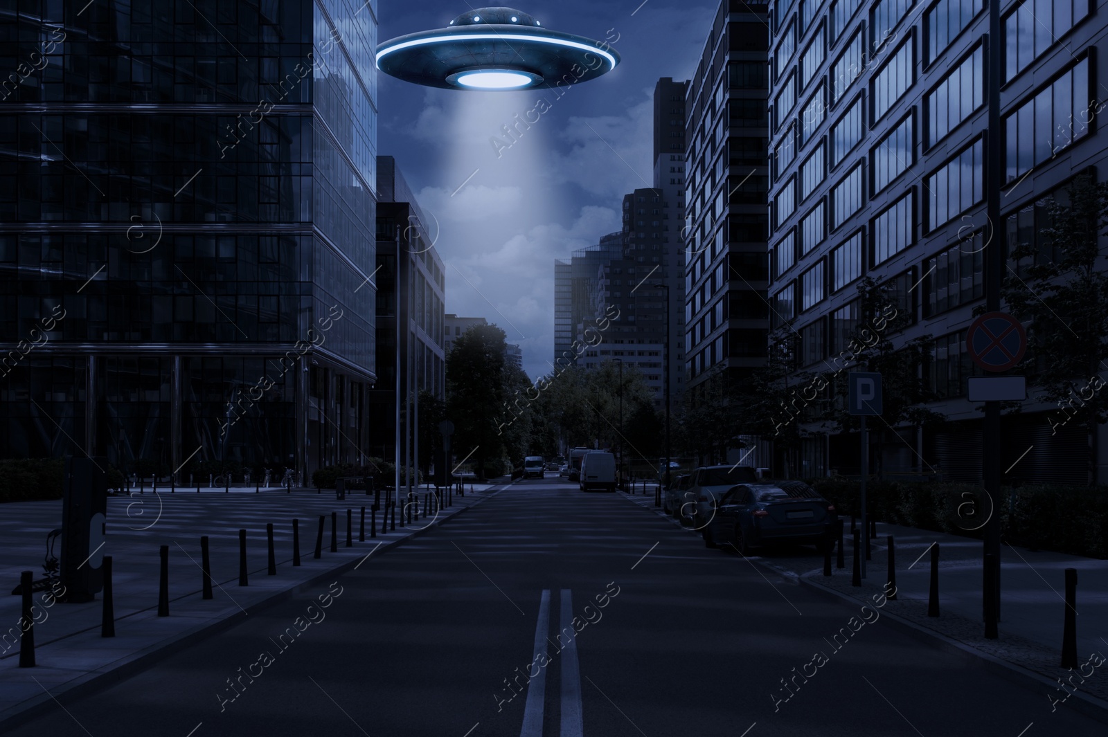 Image of Alien spaceship emitting light over buildings in city. UFO, extraterrestrial visitors