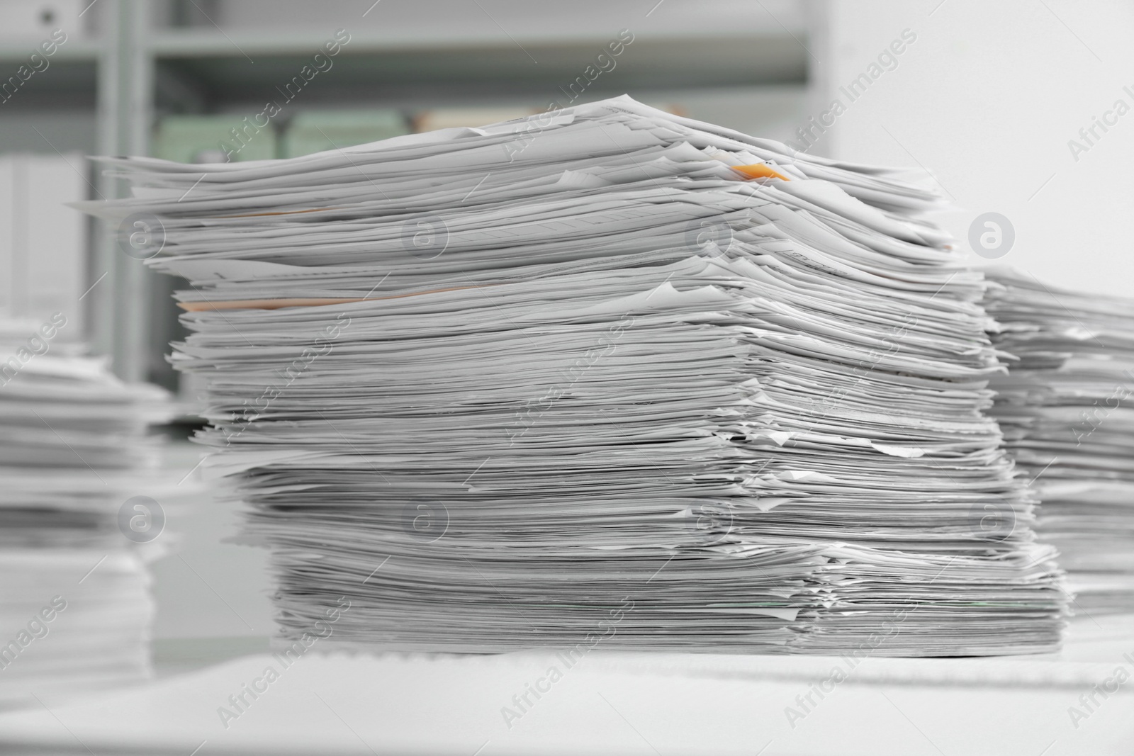 Photo of Stacks of documents on table in office