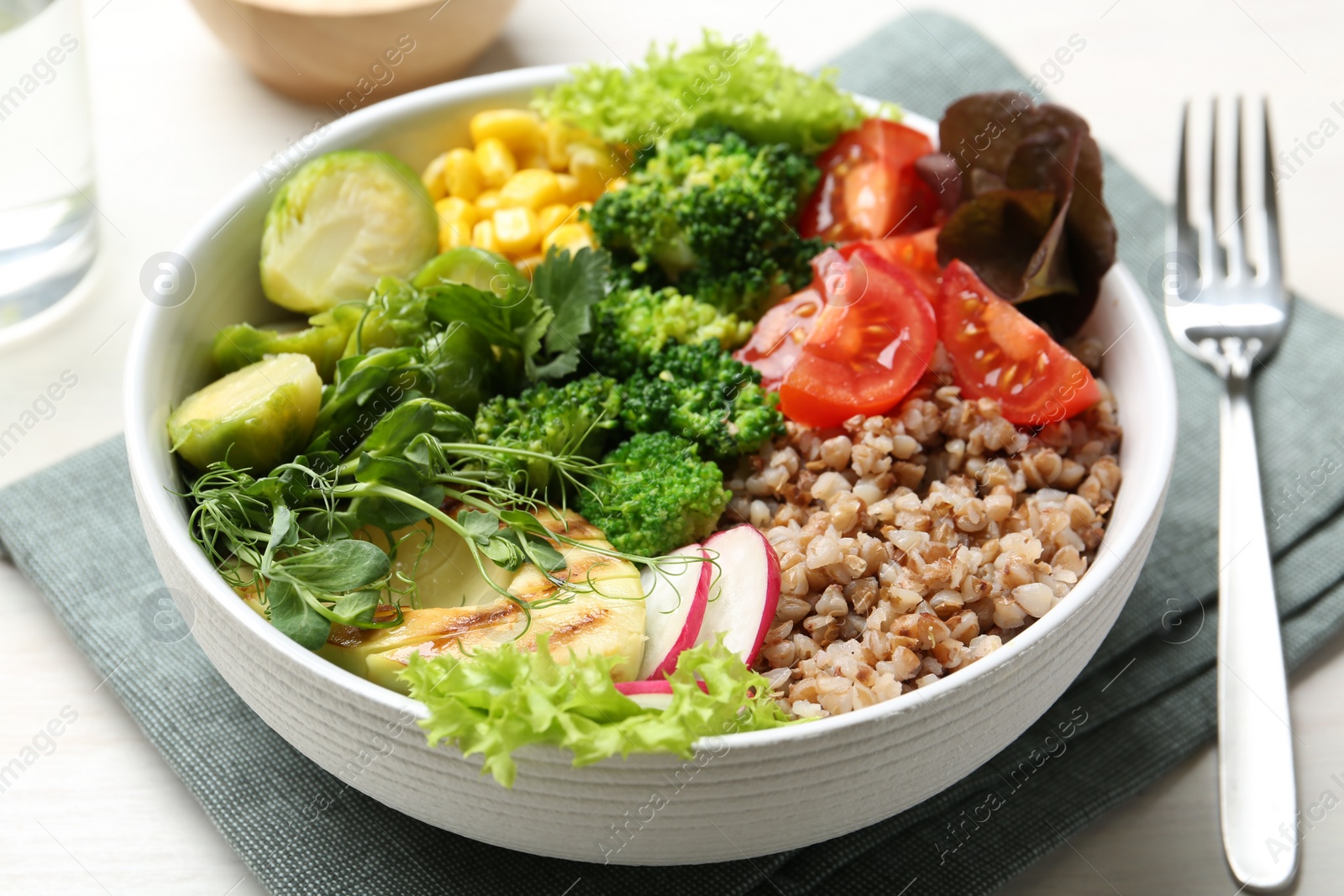 Photo of Healthy meal. Tasty products in bowl on white table, closeup