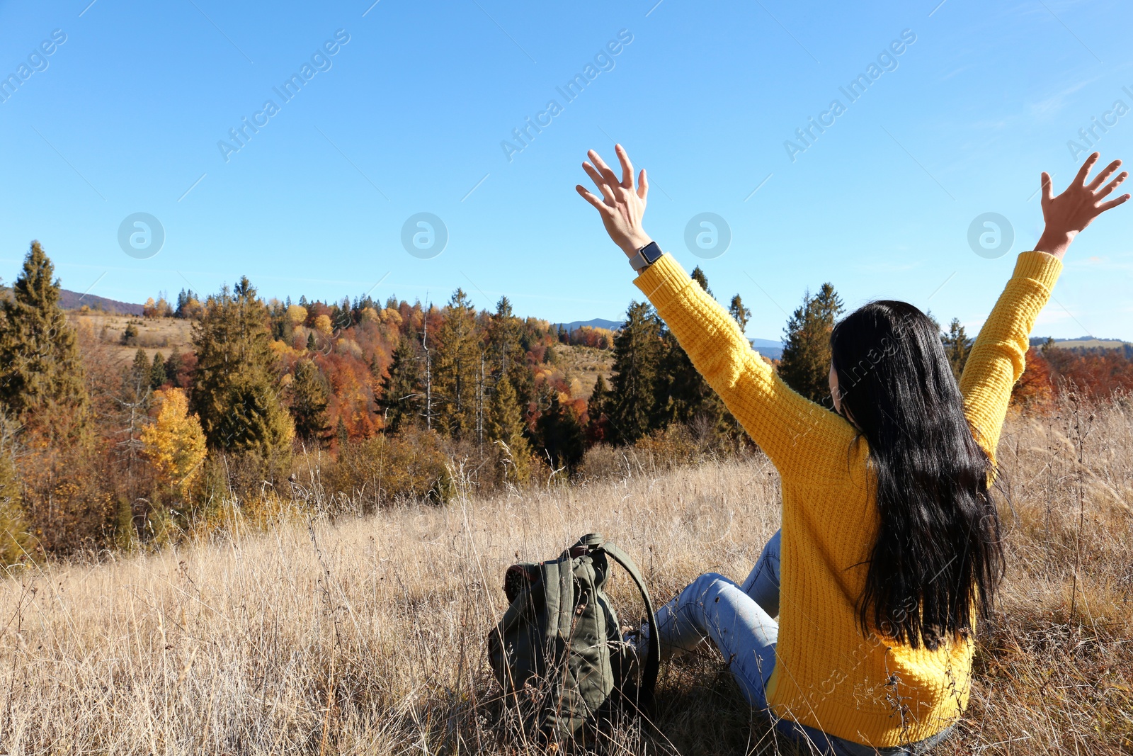 Photo of Female traveler feeling free in peaceful mountains