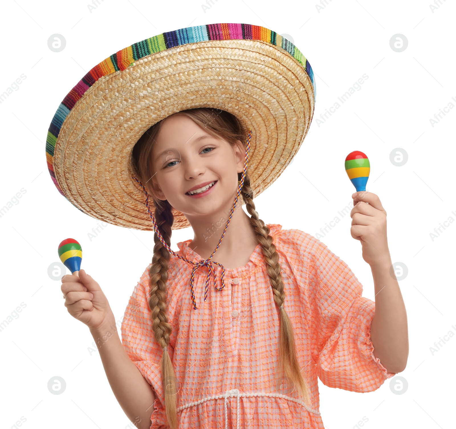 Photo of Cute girl in Mexican sombrero hat with maracas on white background