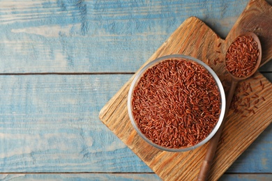 Flat lay composition with brown rice on table. Space for text