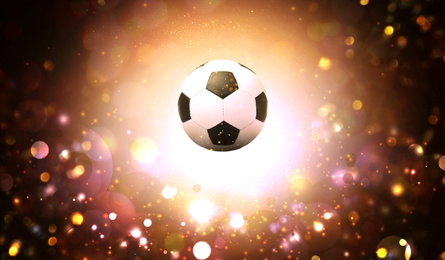 Image of Soccer ball and blurred lights on dark background 