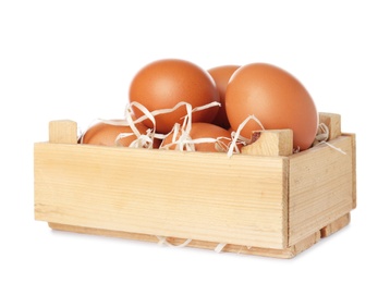 Photo of Wooden crate full of fresh eggs on white background