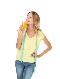 Happy slim woman with measuring tape and glass of juice on white background. Positive weight loss diet results