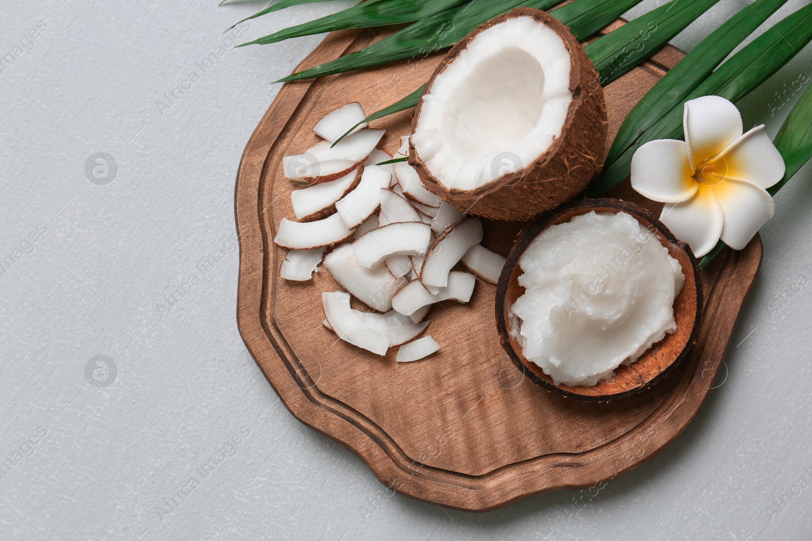 Photo of Beautiful composition with coconut oil and nuts on grey background