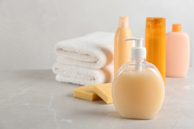 Photo of Fresh towels and toiletries on light grey marble table. Space for text