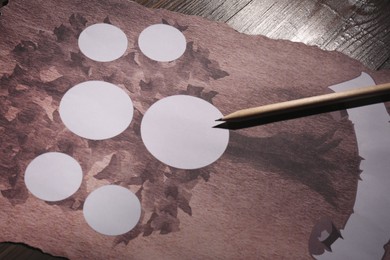 Blank family tree and pencil on wooden table, closeup