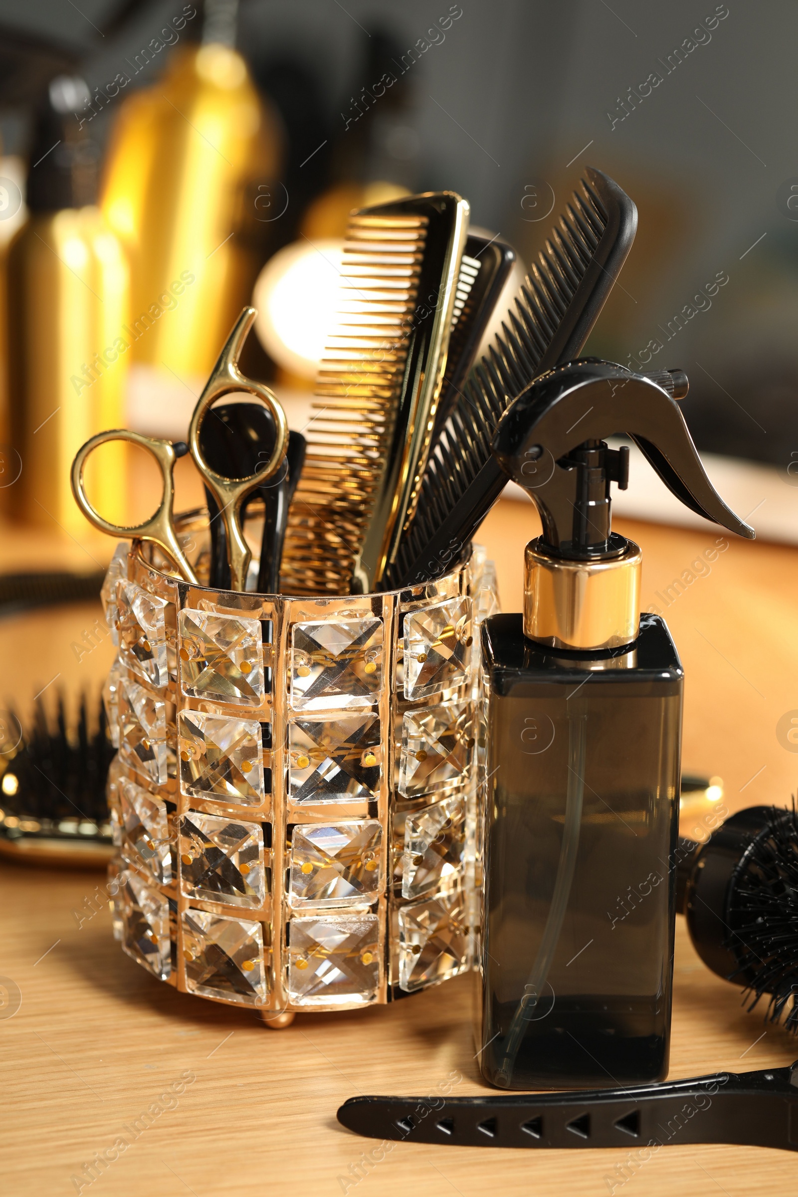 Photo of Set of hairdresser tools on table in salon