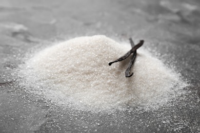 Photo of Vanilla sugar and sticks on grey background