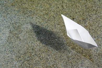 Beautiful white paper boat on water outdoors, space for text