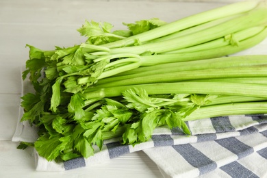 Fresh ripe green celery on white wooden table