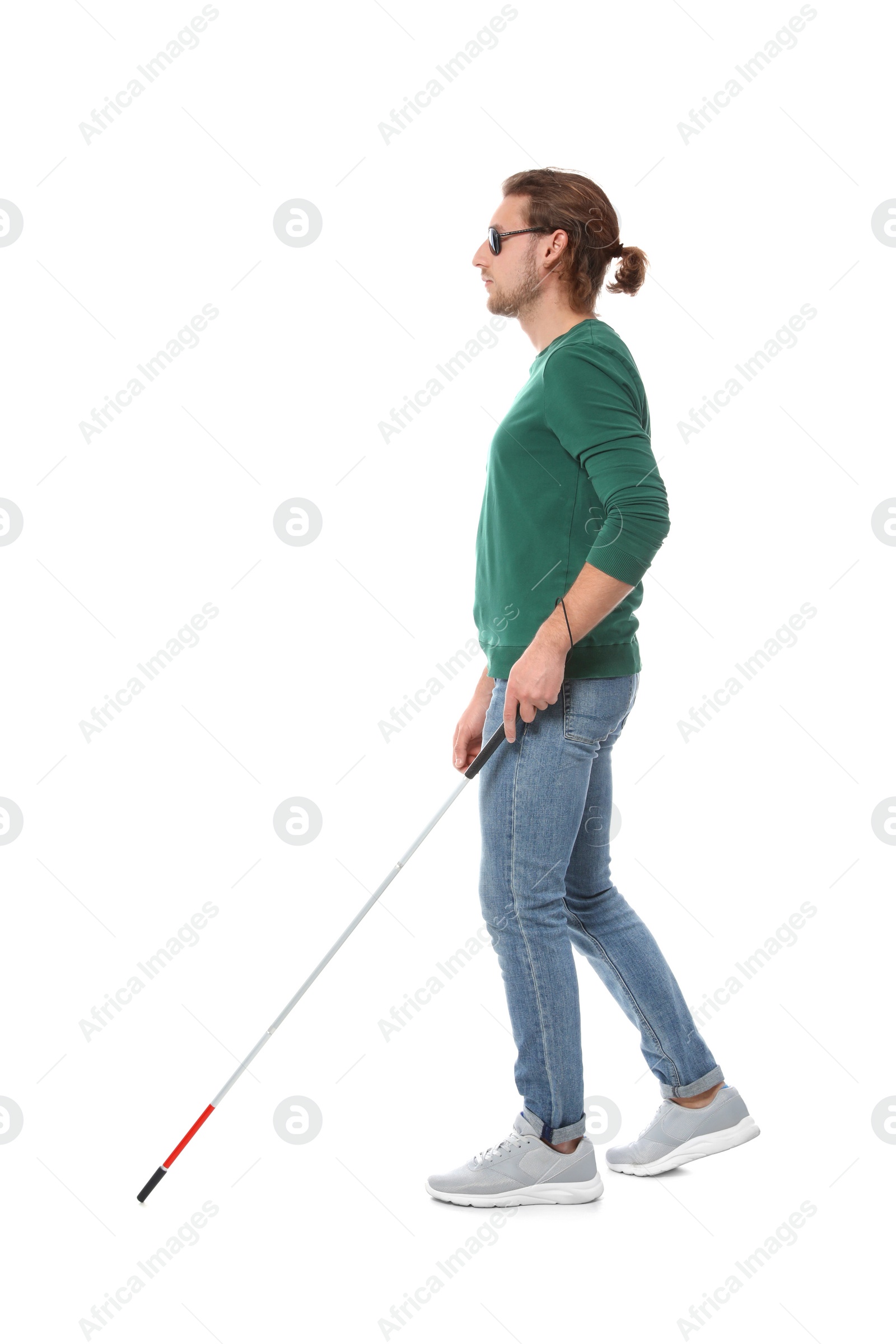 Photo of Blind man in dark glasses with walking cane on white background