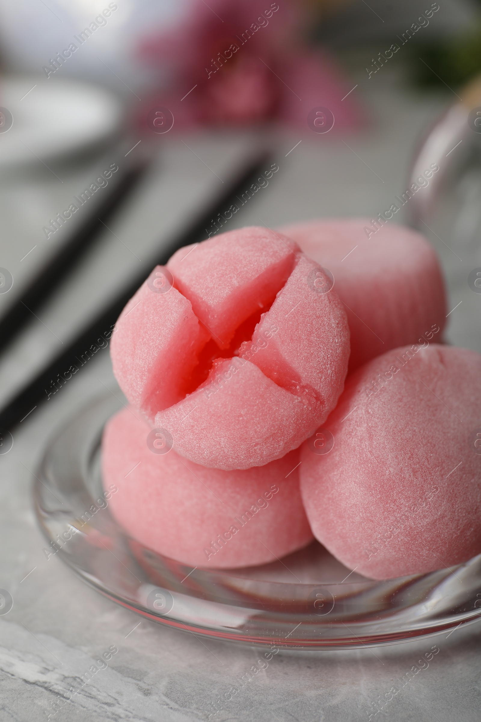 Photo of Glass plate with delicious mochi on grey table, closeup. Traditional Japanese dessert