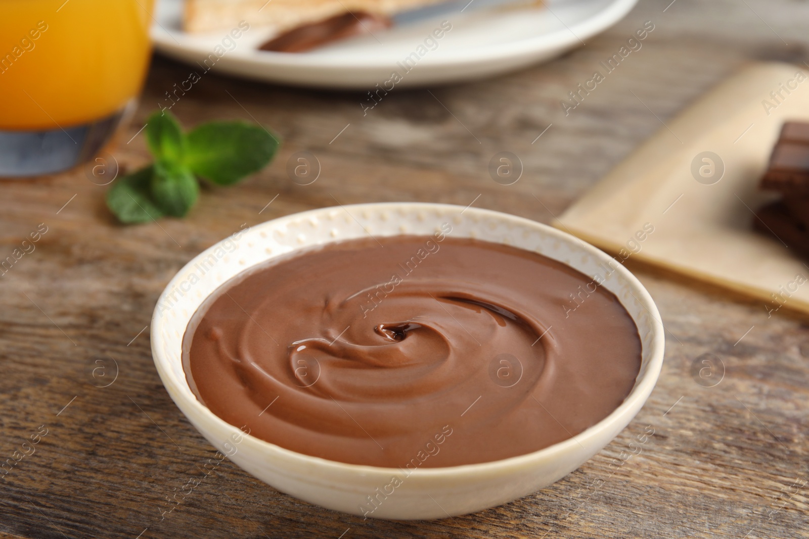 Photo of Dessert bowl with sweet chocolate mousse served on wooden table