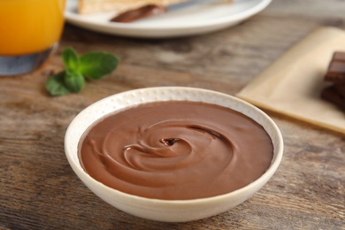 Dessert bowl with sweet chocolate mousse served on wooden table