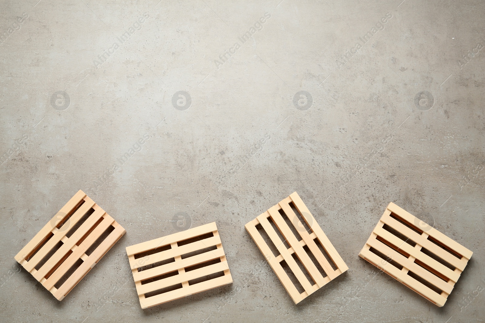 Photo of Wooden pallets on light grey table, flat lay. Space for text