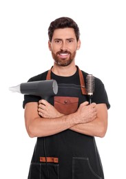 Professional hairdresser holding brush and dryer on white background