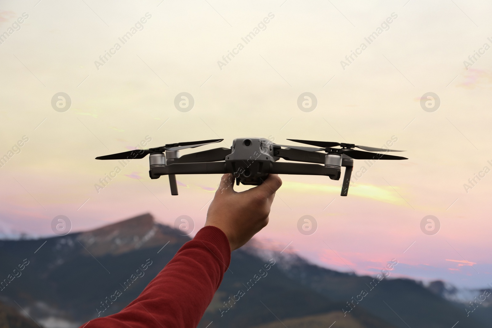 Photo of Man with modern drone in mountains, closeup