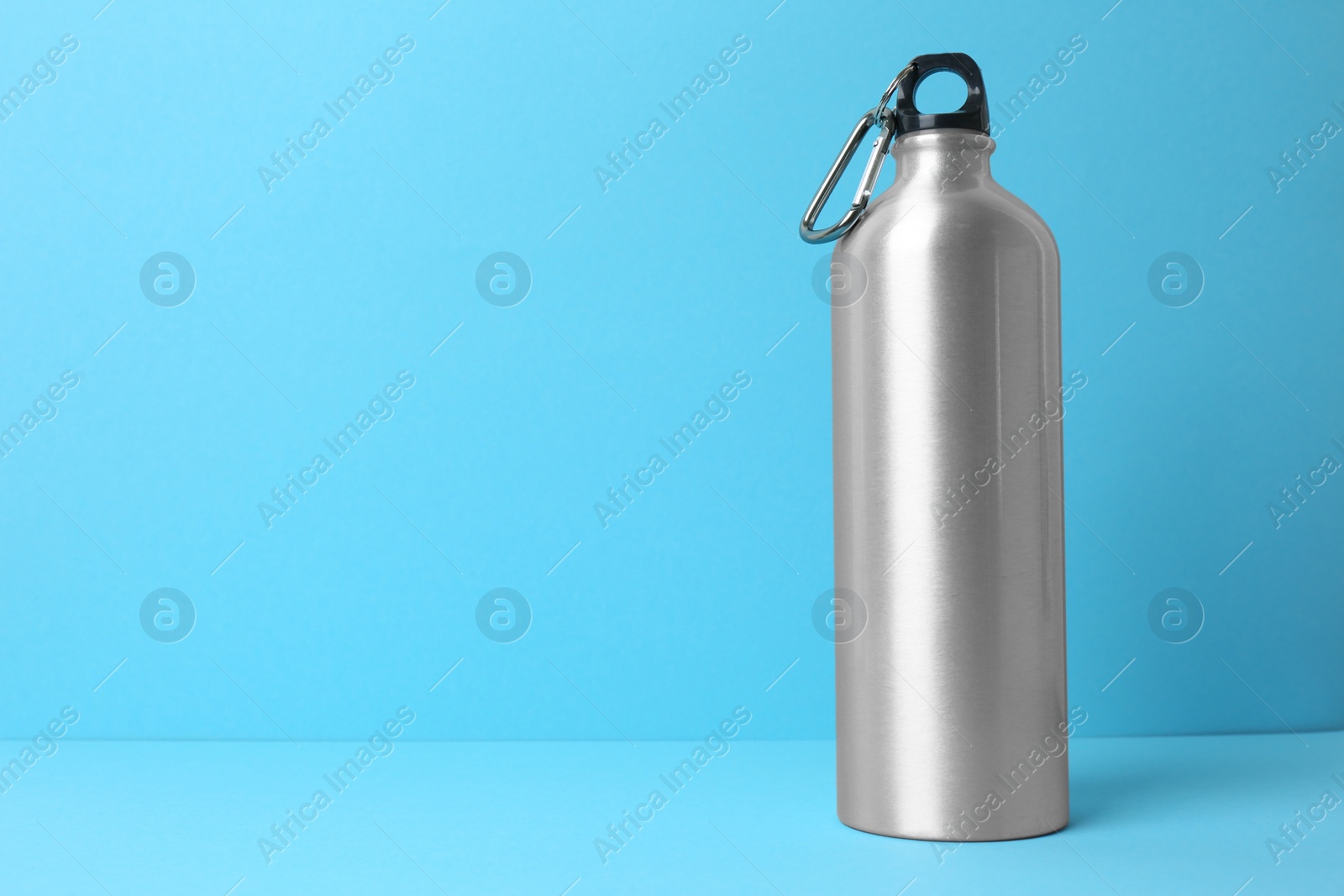 Photo of Sport bottle with space for text on color background