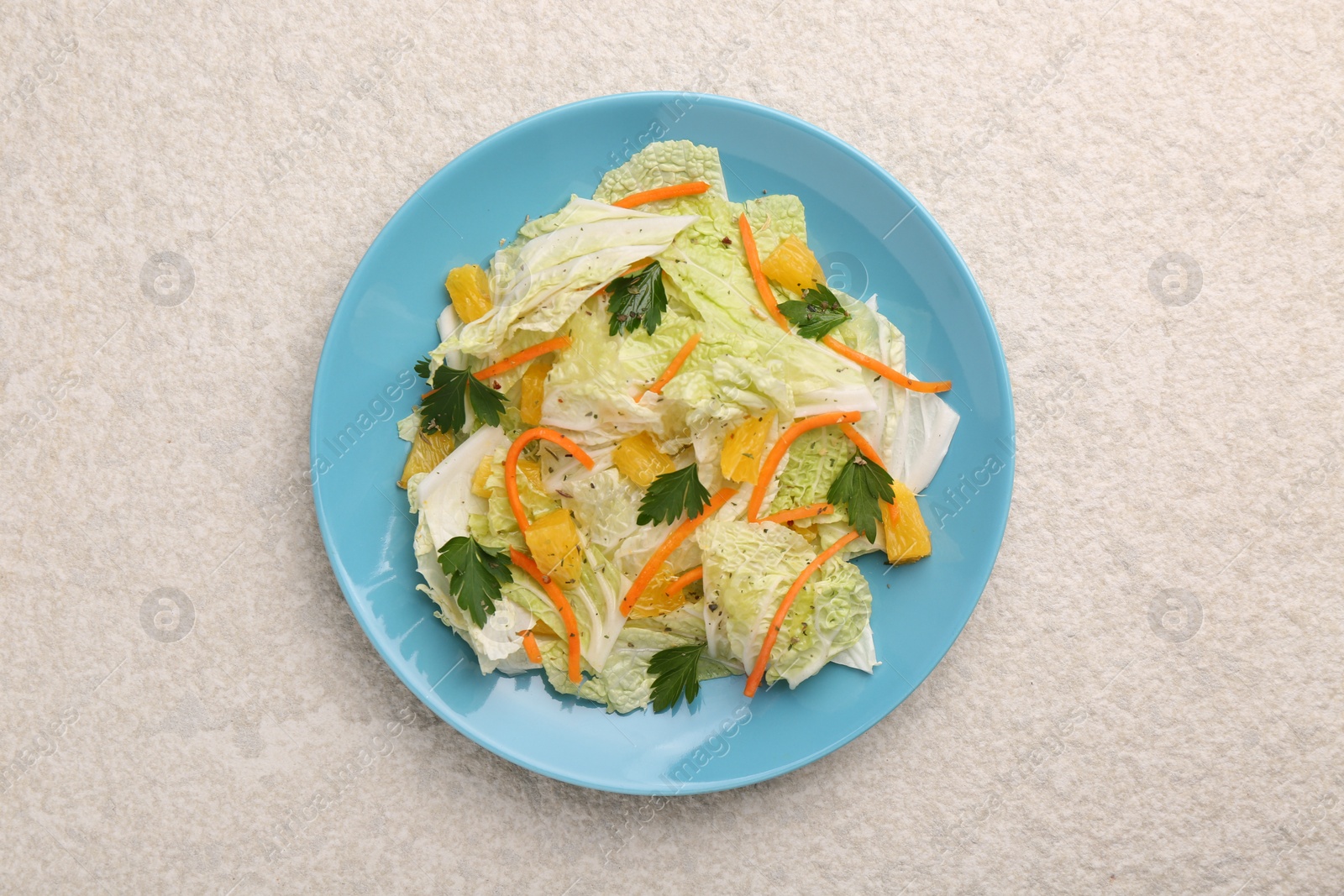 Photo of Tasty salad with Chinese cabbage on beige textured table, top view