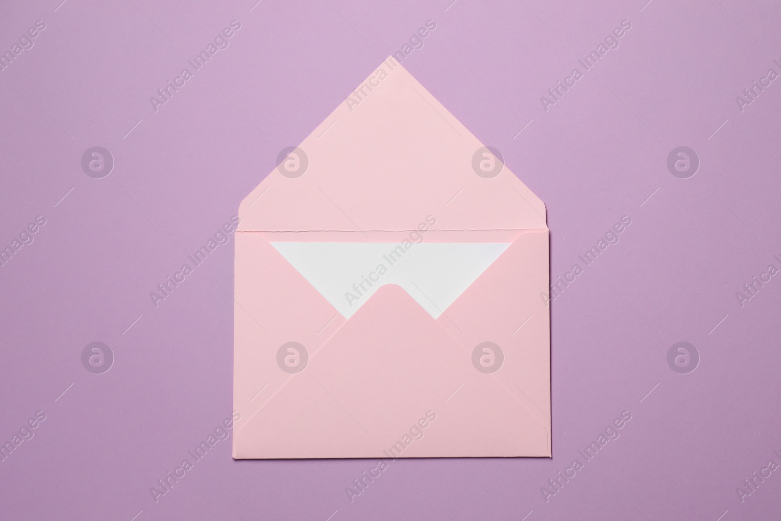 Photo of Letter envelope with card on violet background, top view