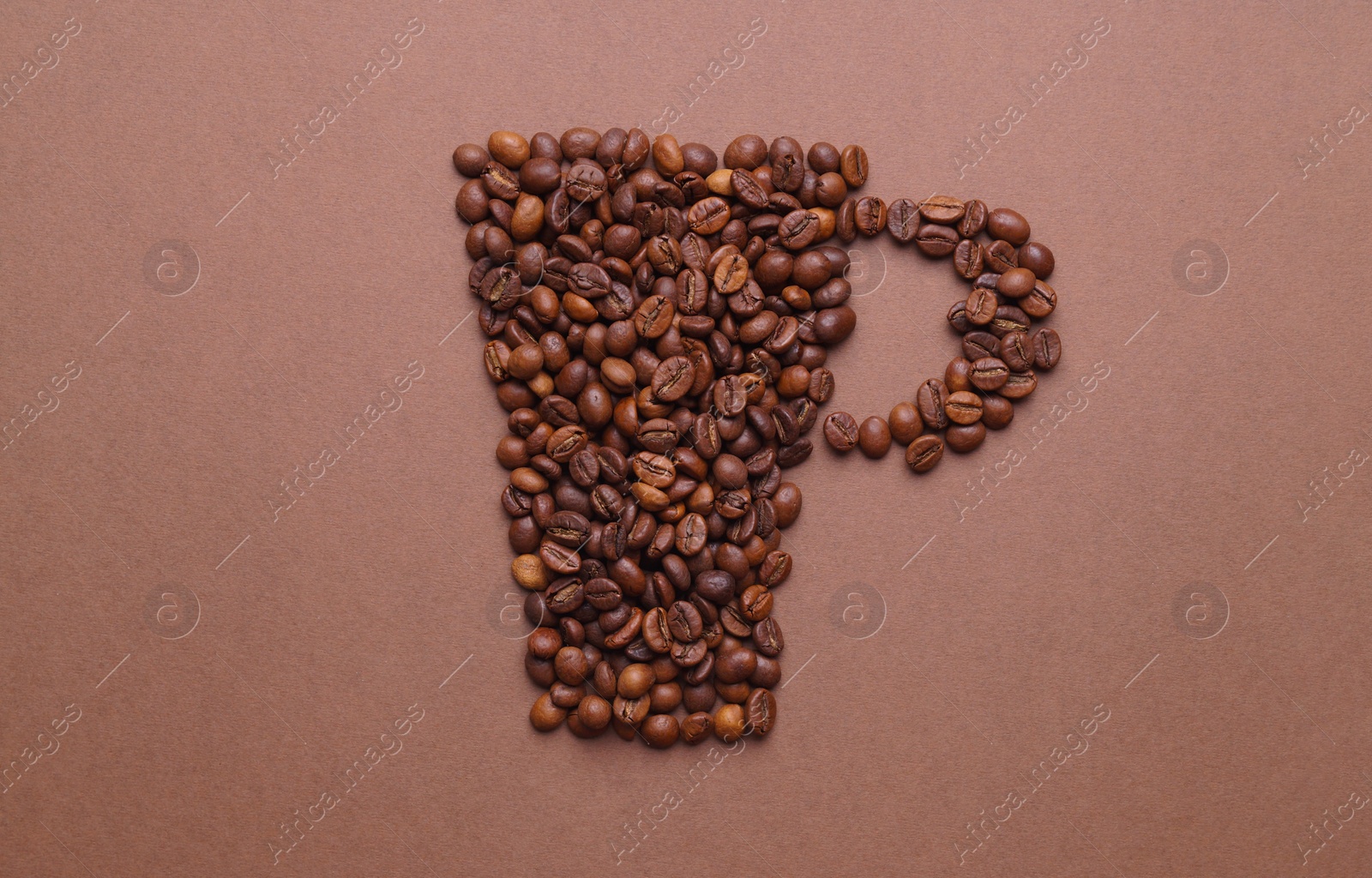 Photo of Cup of drink, composition made with coffee beans on brown background, flat lay