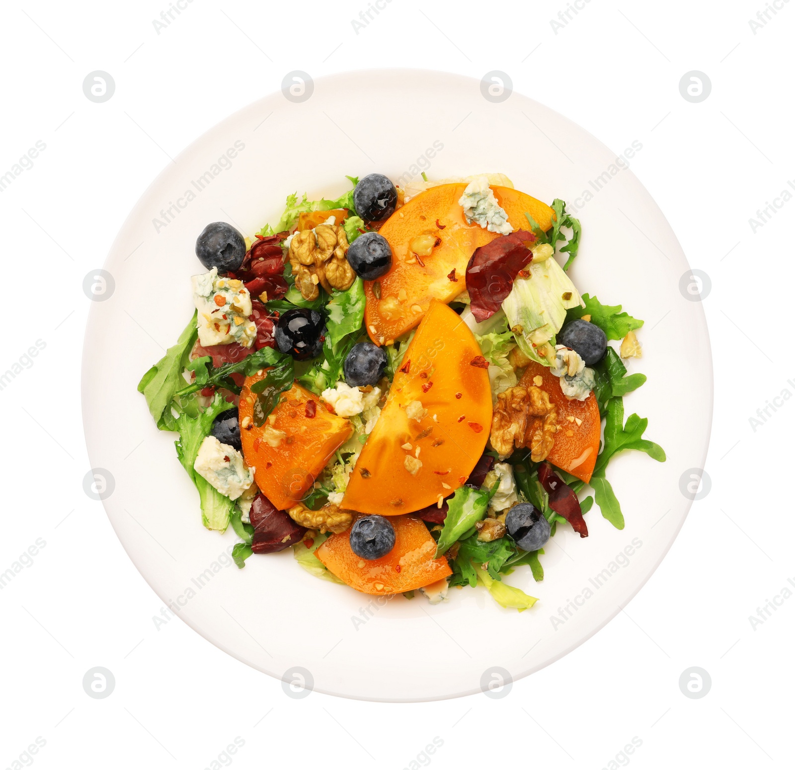 Photo of Delicious persimmon salad with blueberries and arugula isolated on white, top view