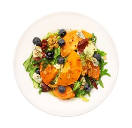 Photo of Delicious persimmon salad with blueberries and arugula isolated on white, top view