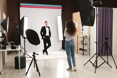 Handsome model posing for professional photographer in studio