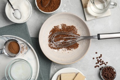 Photo of Whipping cream for dalgona coffee and ingredients on light gray table, flat lay