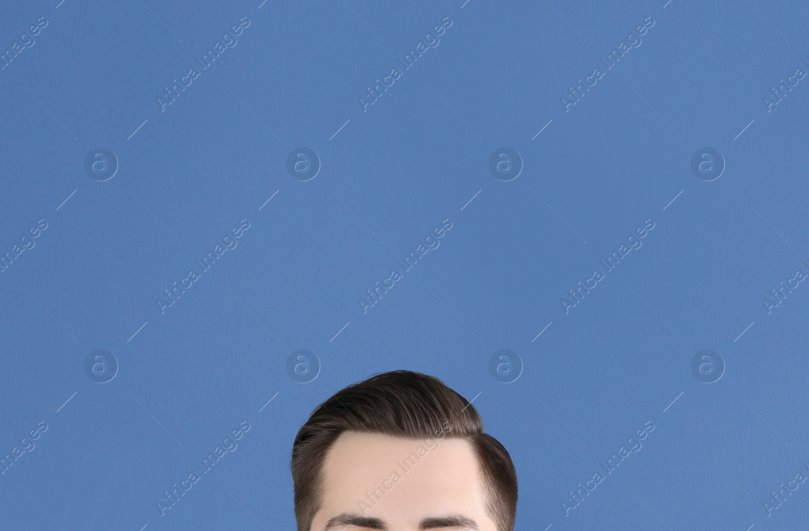 Photo of Man with beautiful hair on grey background, closeup