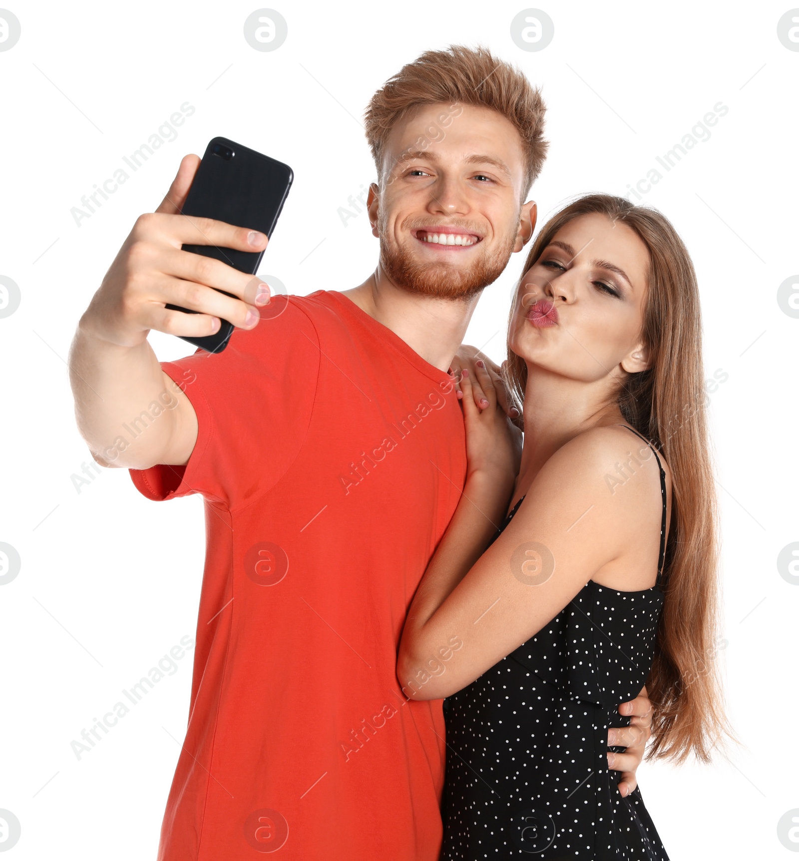 Photo of Happy young couple taking selfie on white background