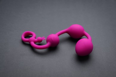 Photo of Pink anal balls on black background. Sex toy