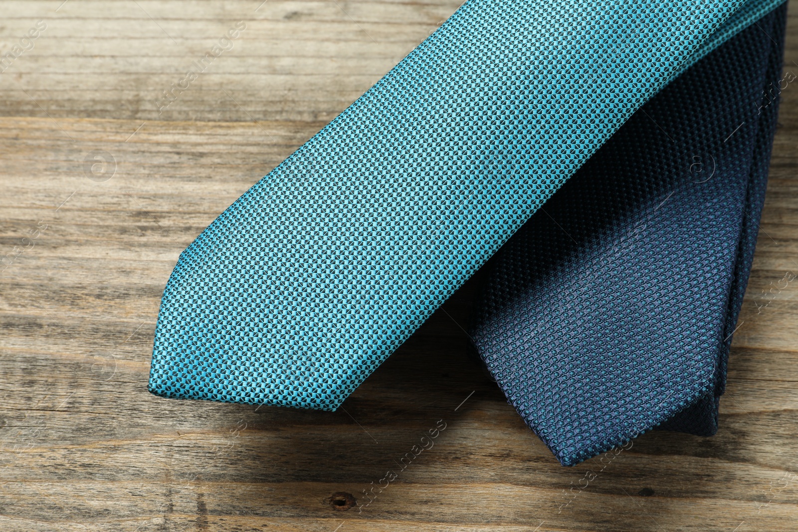 Photo of Two neckties on wooden table, top view