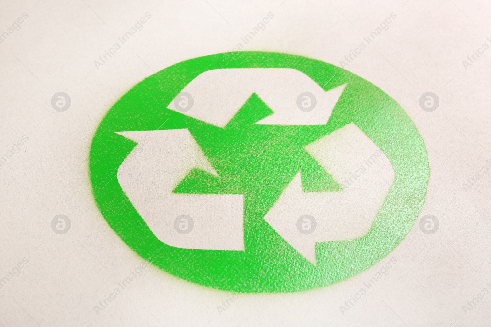 Photo of Recycling symbol on cardboard paper. Waste reuse concept