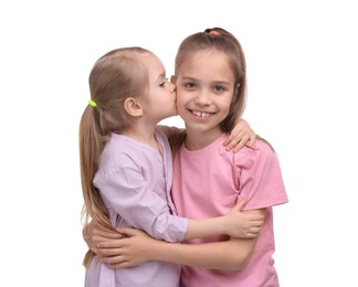Photo of Portrait of cute little sisters on white background