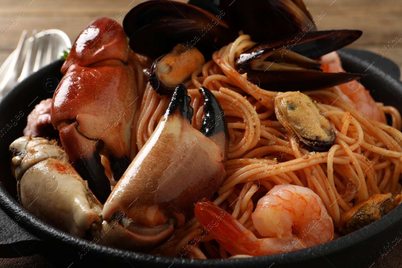 Photo of Delicious spaghetti with seafood on table, closeup