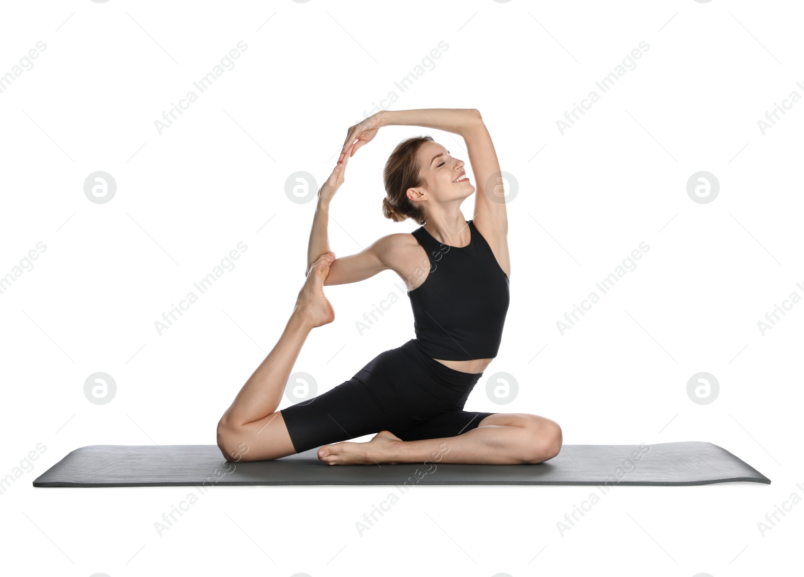 Photo of Young woman in sportswear practicing yoga on white background