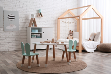 Cute children's room interior with bed and little table